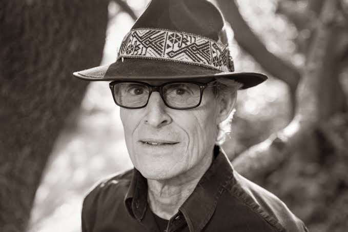 A portrait of George Bertelstein, captured in a serene and thoughtful pose with a cacao drink