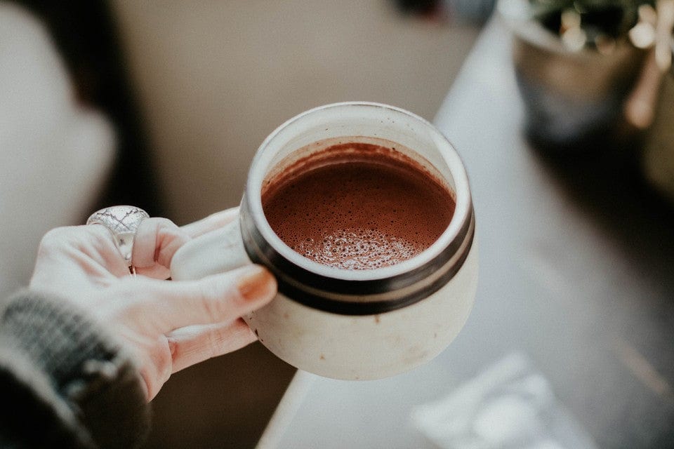 Mug with ceremonial cacao and warm, inviting ambiance