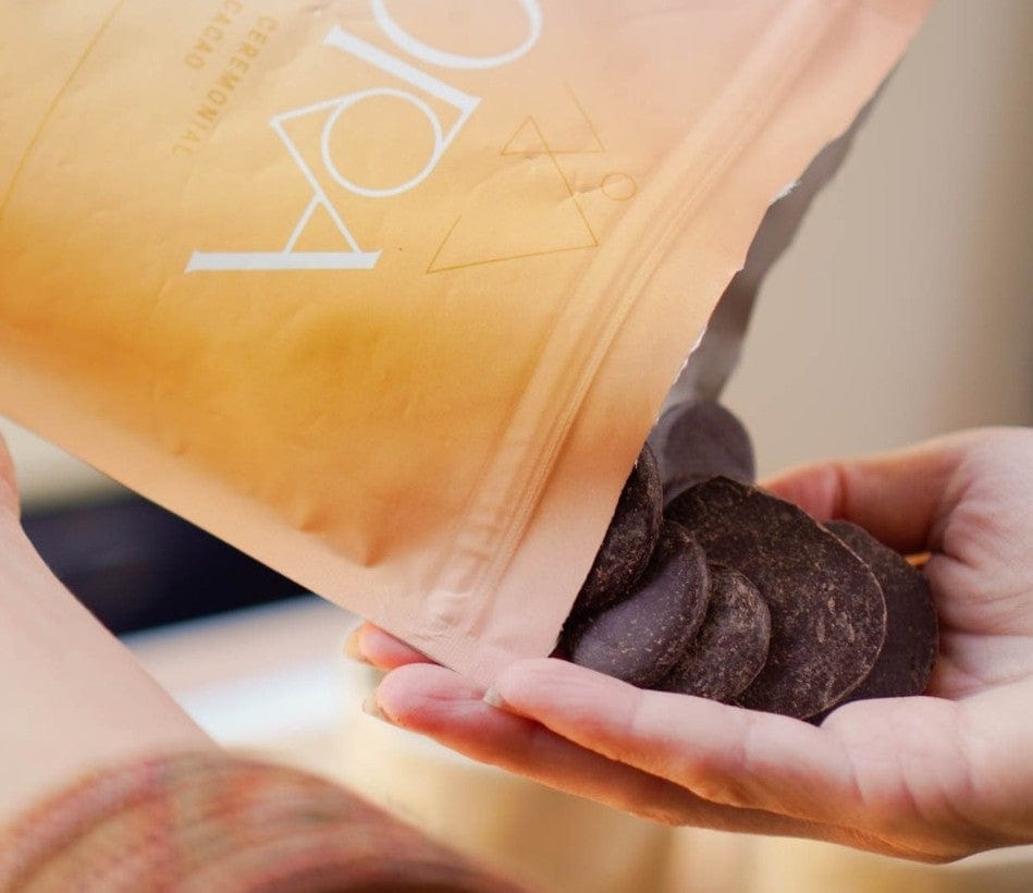 Holding Ora Cacao discs, showcasing the purity and richness of ceremonial-grade cacao in every piece